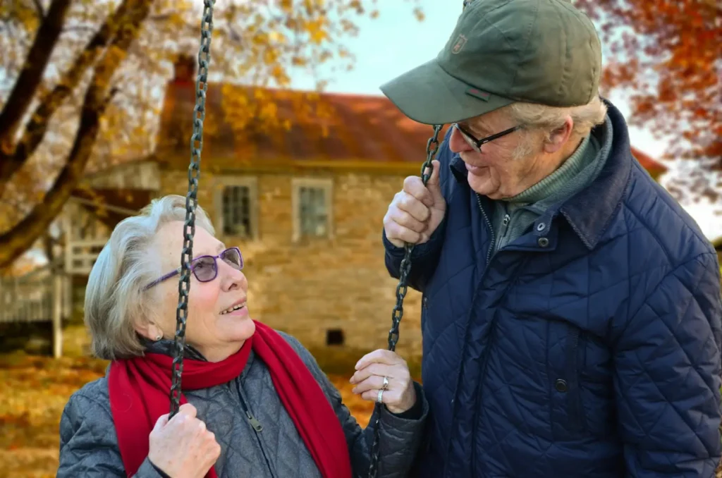 Smiling older couple enjoying time together outdoors, symbolizing vitality, emotional well-being, and a healthy lifestyle in later years.