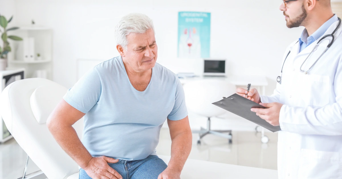 Male patient in conversation with a doctor during a consultation about prostate health, discussing symptoms, risks, and treatment options.